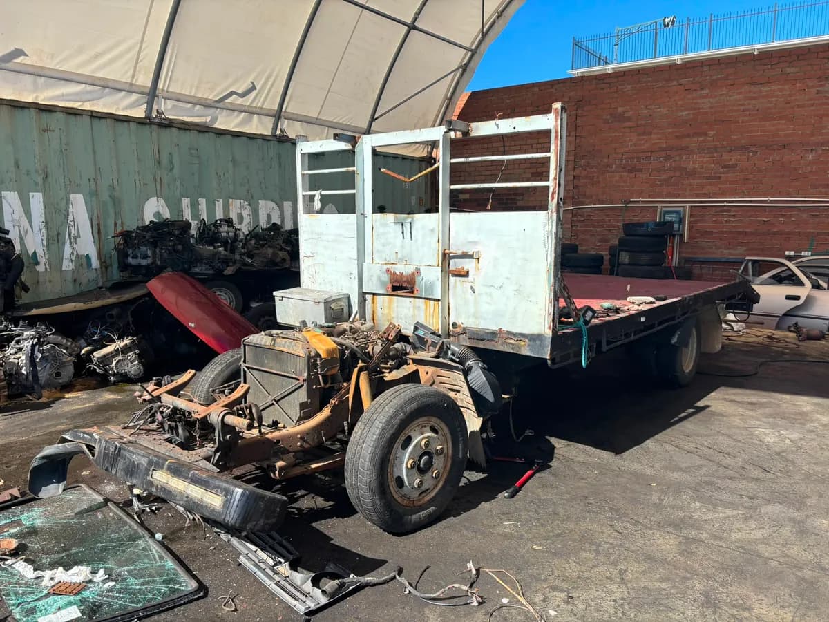 Toyota Dyna truck cab being removed during dismantling at Midland Wreckers Bellevue yard