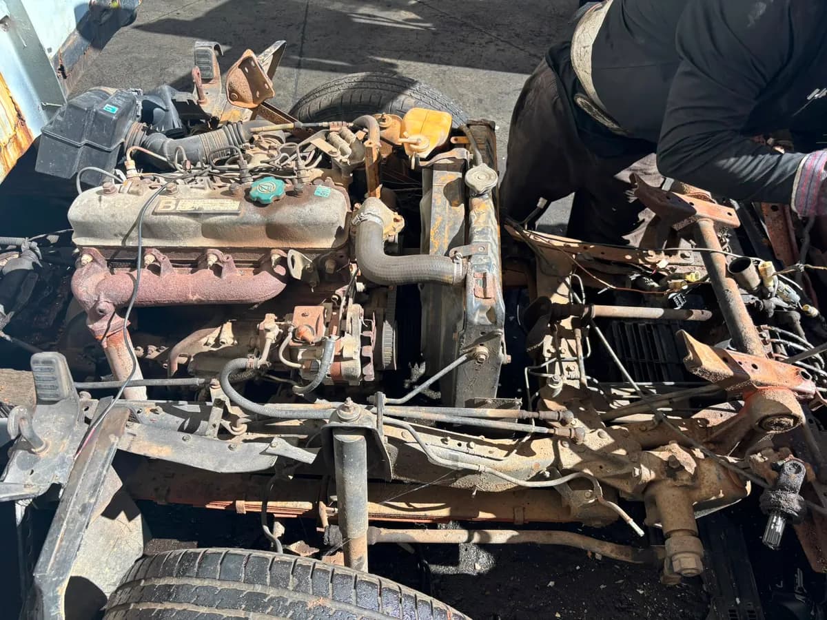 Toyota Dyna diesel engine and chassis being dismantled for parts at Perth wreckers