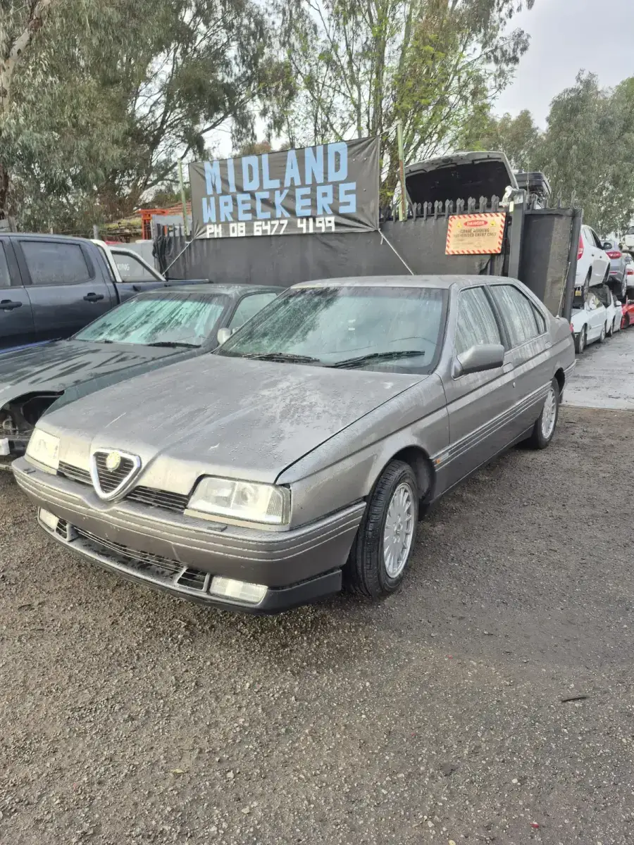 Alfa Romeo 164 front three-quarter showing turbine alloys at Midland Wreckers Perth