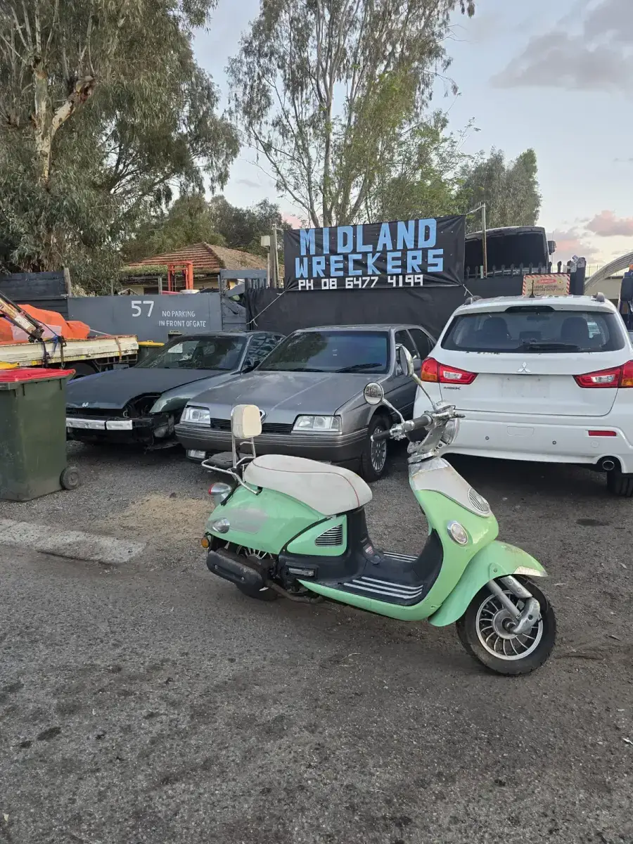 Unregistered retro scooter at the Midland Wreckers Bellevue yard ready for dismantling